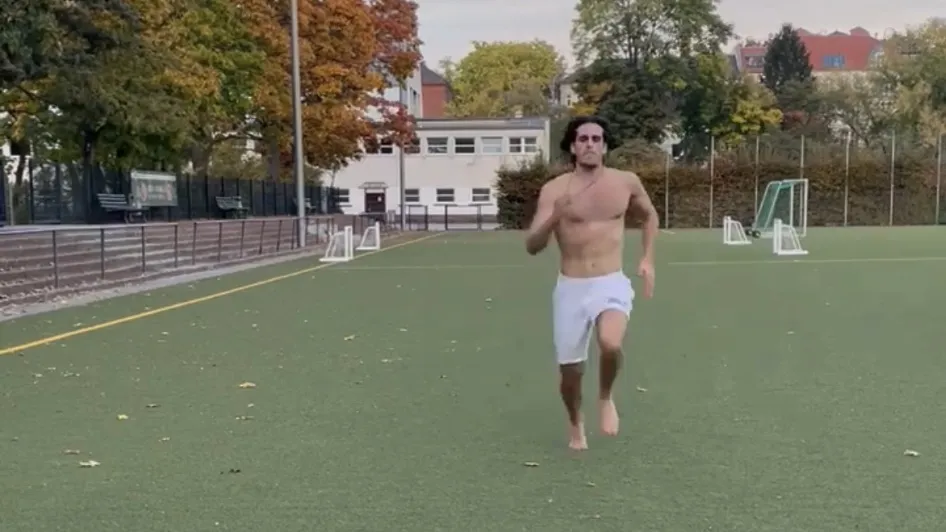 Running barefoot across a turf field.